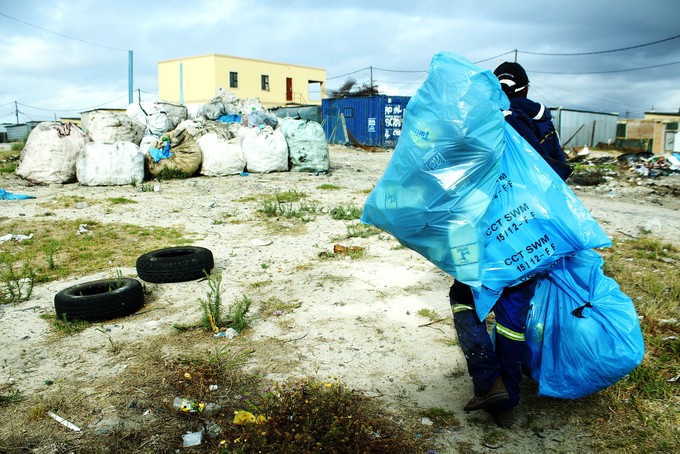 Photo of Plaatjies taking bags of scrap to the scrapyard.