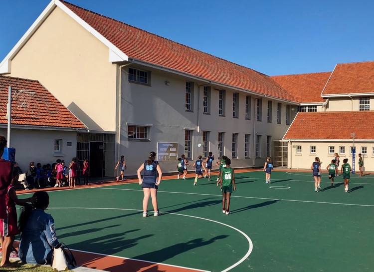 Photo of children playing netball at a school