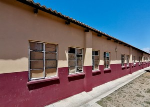 Photo of school building with broken windows