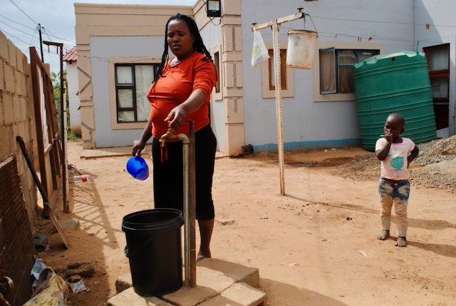 Photo of a woman at a tap