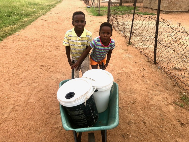 Photo of two children with buckets