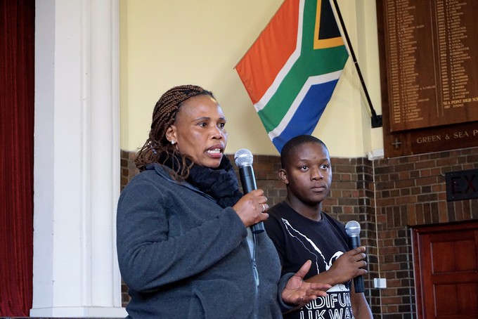 Photo of two women speaking at public meeting