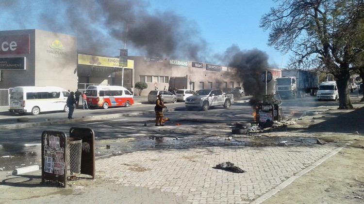 Photo of Butterworth with smoke and rubble