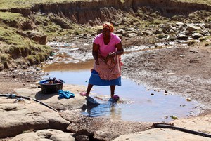 Photo of a woman doing washing