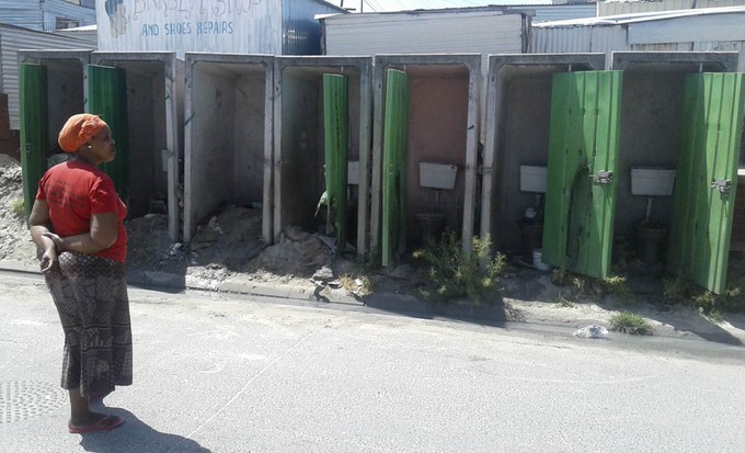 Photo of woman in front of toilets