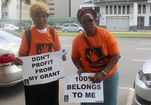 Photo of two protesters against social grant deductions