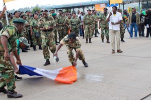 Photo of people in military clothing burning old SA flag