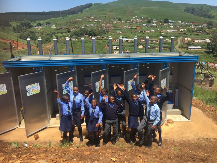Photo of learners in front of toilets