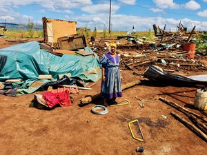 Photo of a woman standing in debris