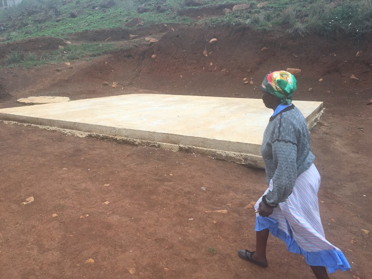 Photo of woman walking past slab of concrete