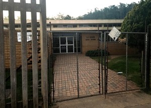 Photo of gates and a brick building