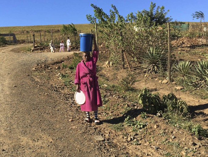 Photo of woman carrying water