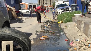 Photo of man cleaning street