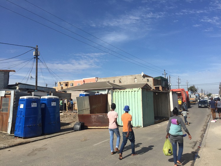 Photo of shipping containers and people