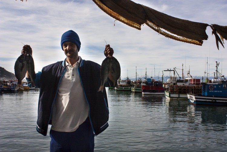 Photo of man holding up fish
