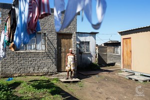 Photo of a woman in a yard with washing