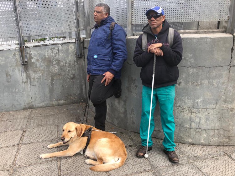 Photo of two men and a dog
