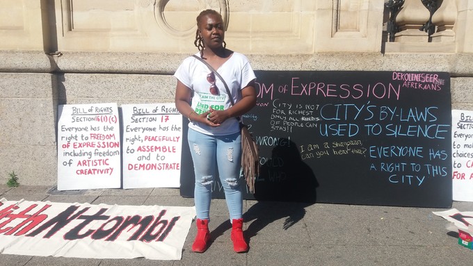 Photo of woman in front of posters