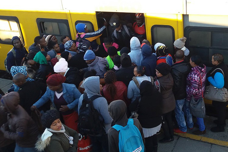 Photo of a crowd of people getting into a train
