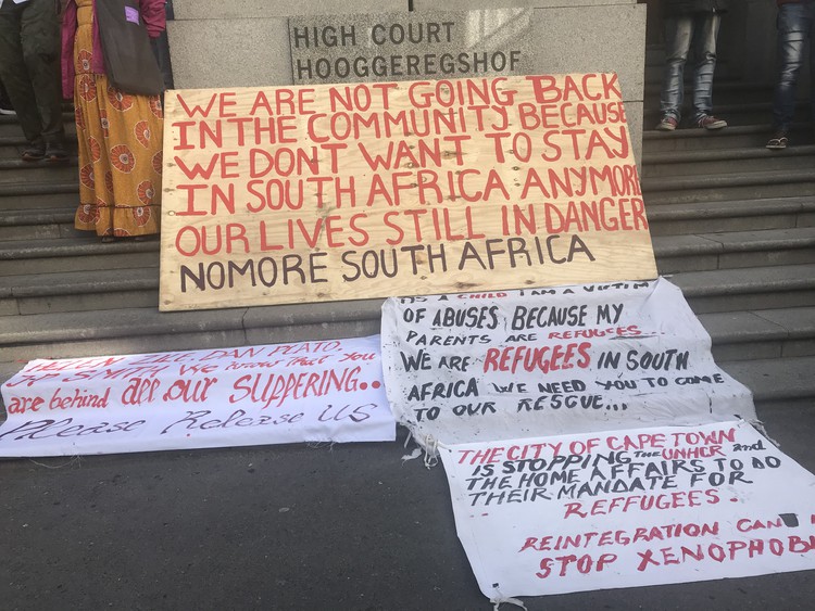 Photo of refugee protest placards outside Cape High Court