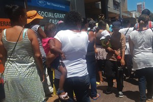 Photo of social grant recipients in a queue