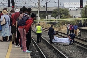 Photo of covered body on railway tracks