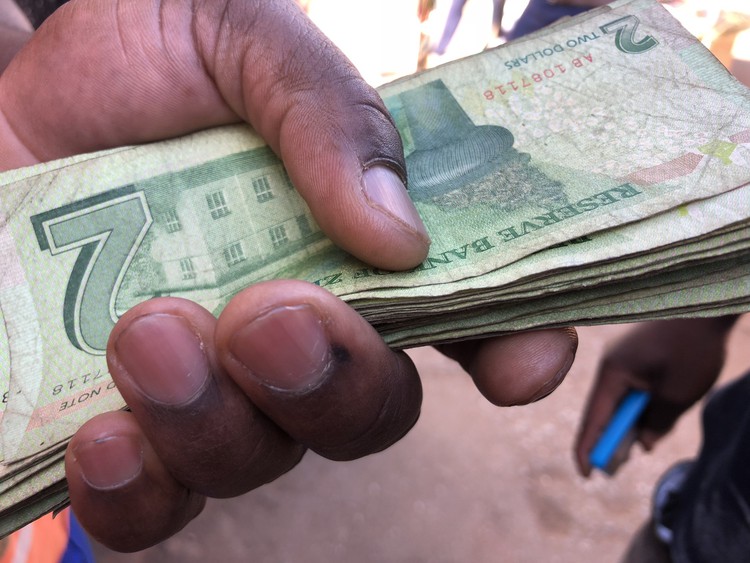 Photo of Zimbabwe bond notes being exchanged