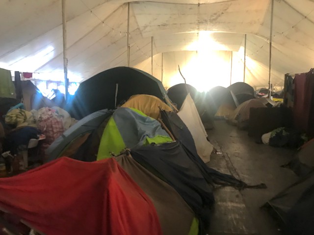 Photo of a tent city inside a marquee