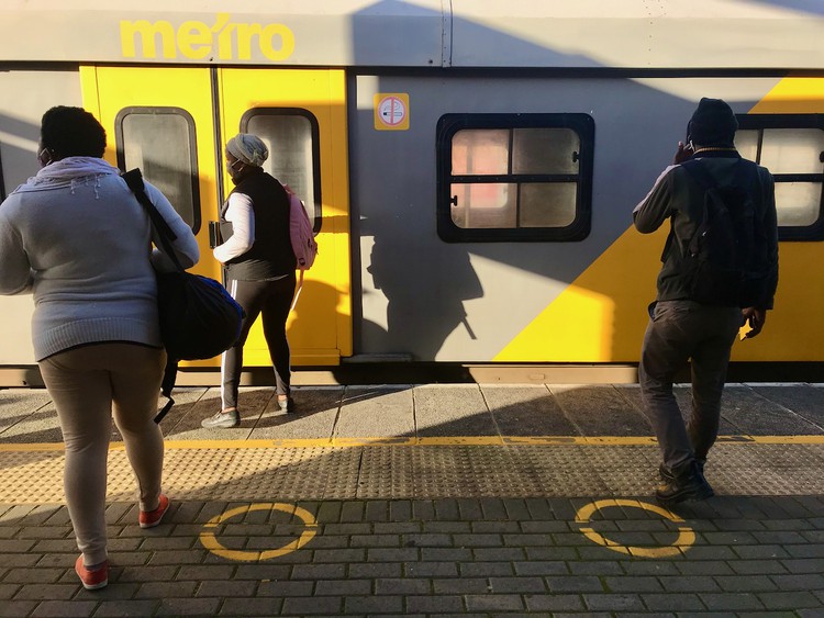 Photo of people getting into a train