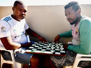 Photo of two people playing draughts