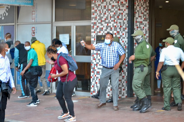 Photo of a protest and a man with a pepper spray