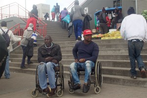 Photo of two men in wheelchairs
