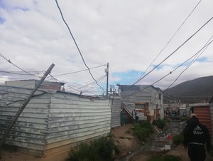 Photo of wires going into shacks