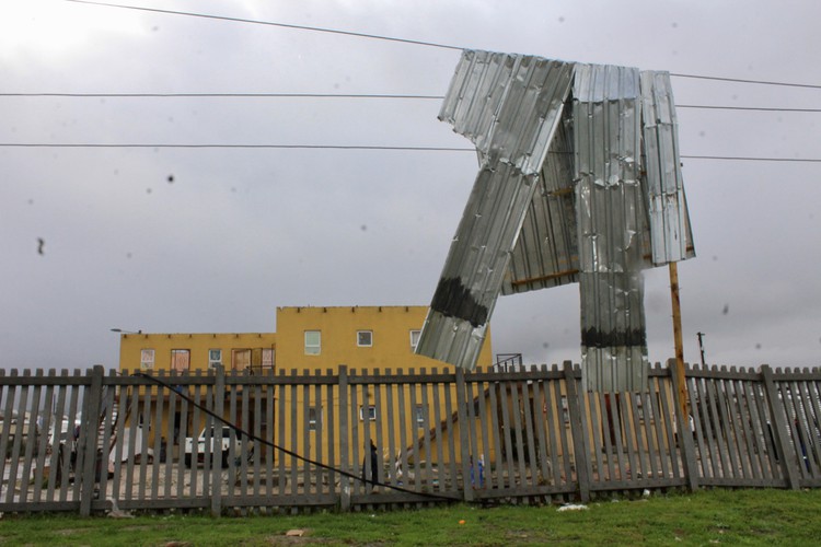 Photo of a shack room hanging on overehead electrical wires