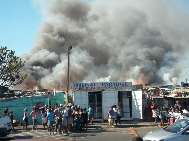 Photo of fire among shacks