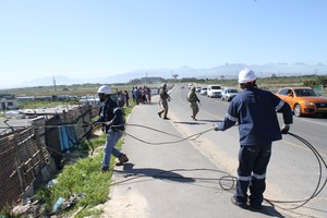 Photo of eskom workers removing illegal connections