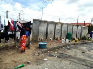 Photo of women hangigng up washing near a row of toilets
