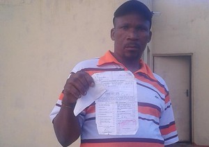 Photo of man holding Home Affairs document