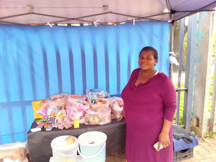 Elizabeth Makofane, who sells snacks and scones outside the Mears station, says she is able to make a living now that the station is functioning again.