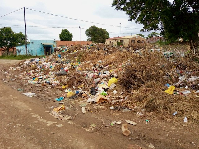 Photo of a dumping site on a street corner