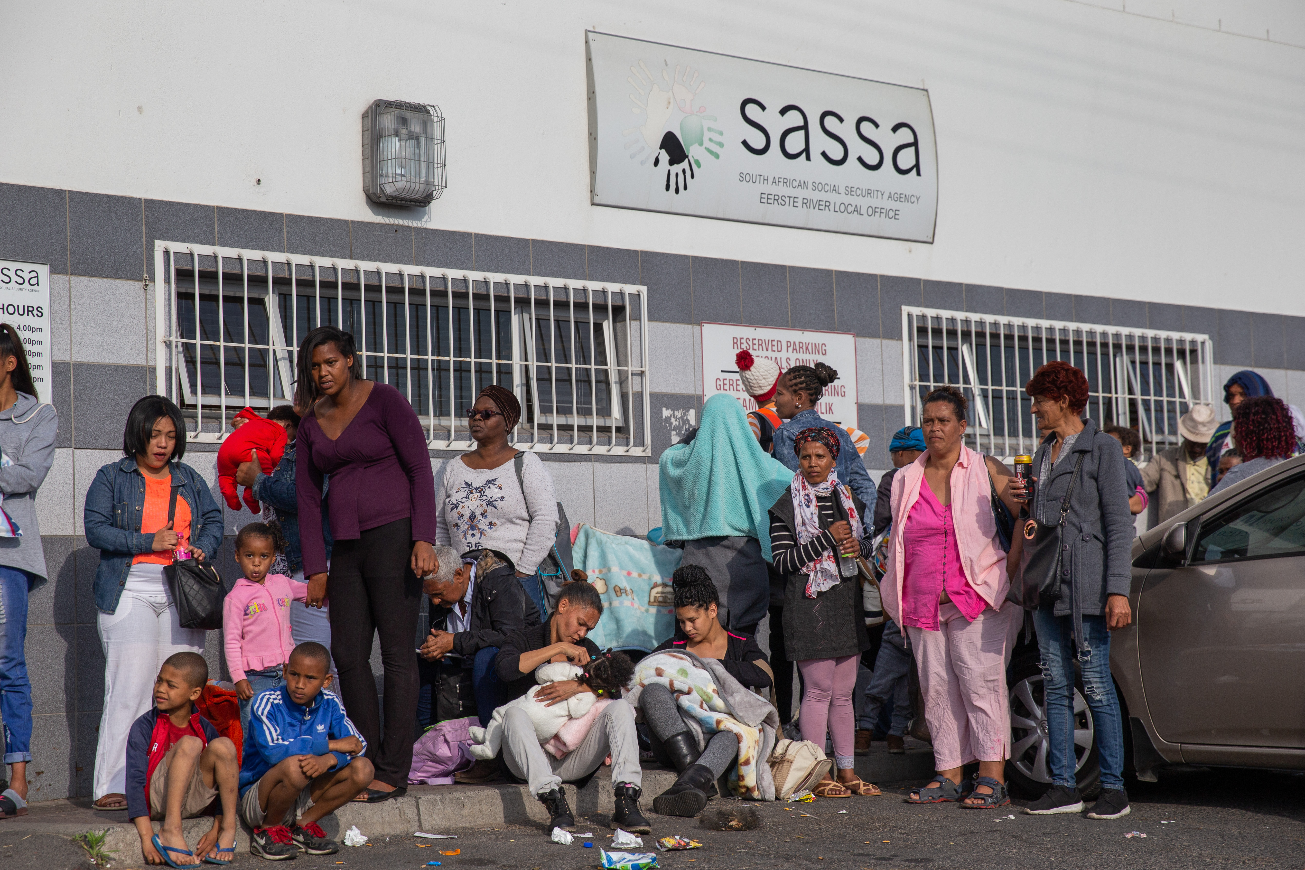 Photo of social grant beneficiaries outside a SASSA office