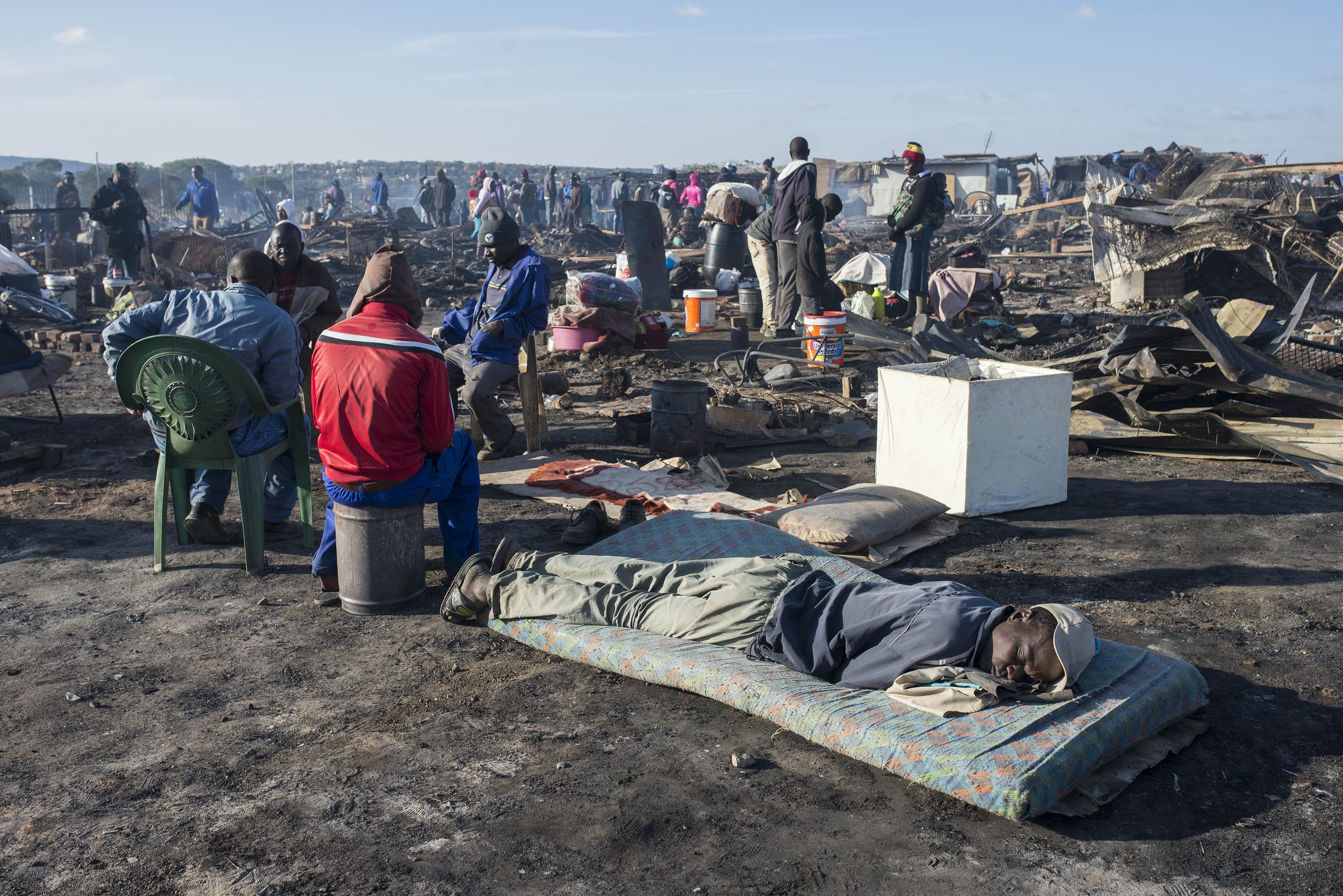 Photo of people in burnt out settlement