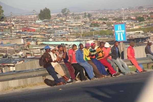Group of men standing on a roadside
